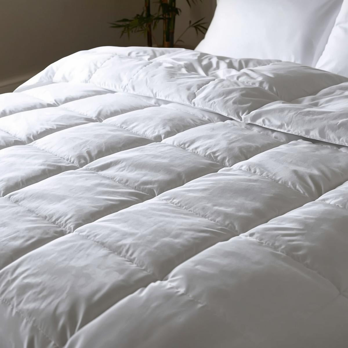 Soft natural bamboo duvet on a cozy bed, breathable, hypoallergenic, and eco-conscious.