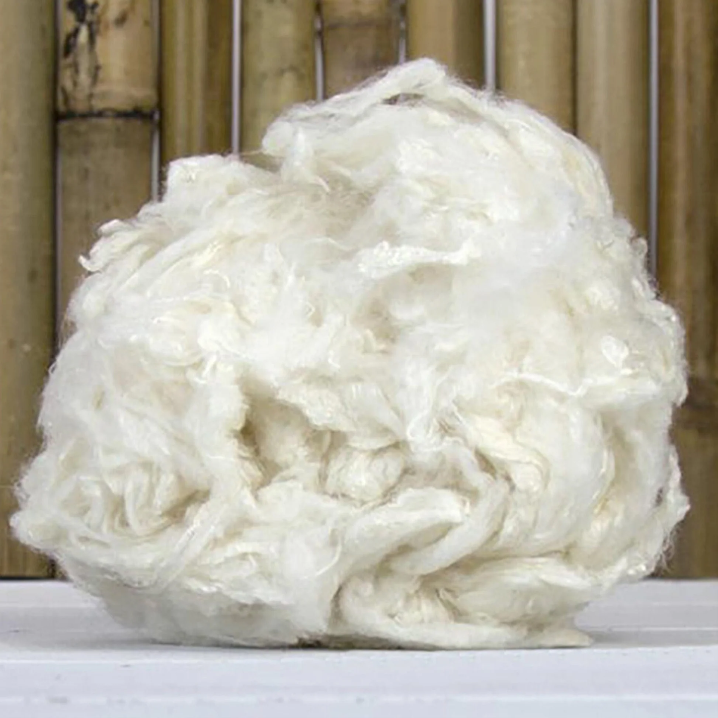 Ball of bamboo fiber with a wooden background